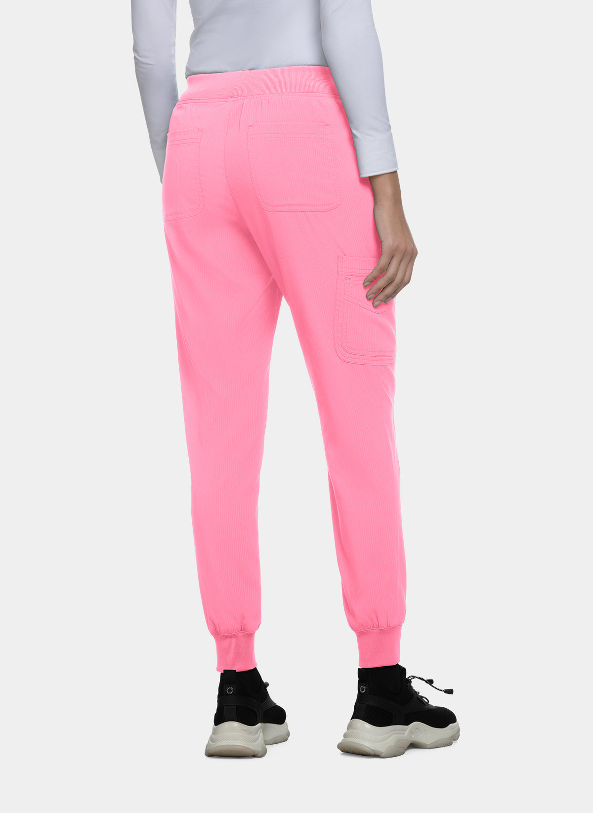 Women's bright pink jogger scrub trousers with ribbed cuffs, back patch pockets, and utility pocket, shown from the rear, worn by a model.