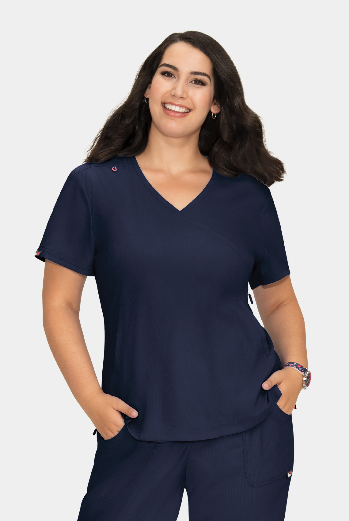 Women's navy V-neck scrub top with short sleeves, worn with matching scrub trousers, front view.