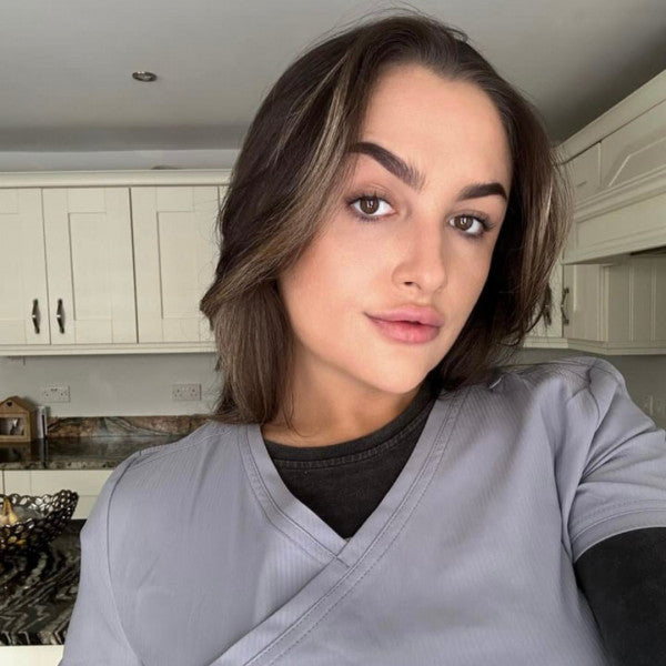 Transgender women wearing grey scrub