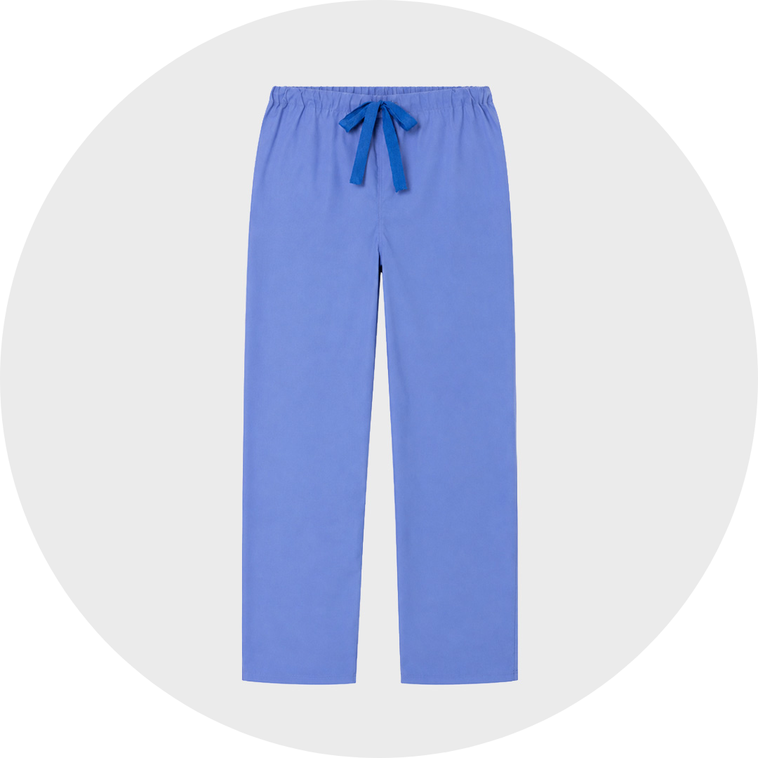 Periwinkle cheap blue basic scrub trousers with an elastic drawstring waist tied in a contrasting navy ribbon, no pockets, shown flat against a light gray circular background.