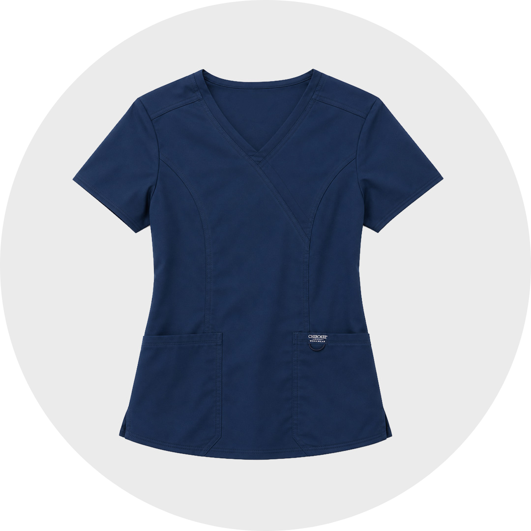 Navy blue short-sleeved cherokee V-neck dental scrub top with a wrap-style front, curved seams, and two large lower front pockets, shown flat against a light gray circular background.