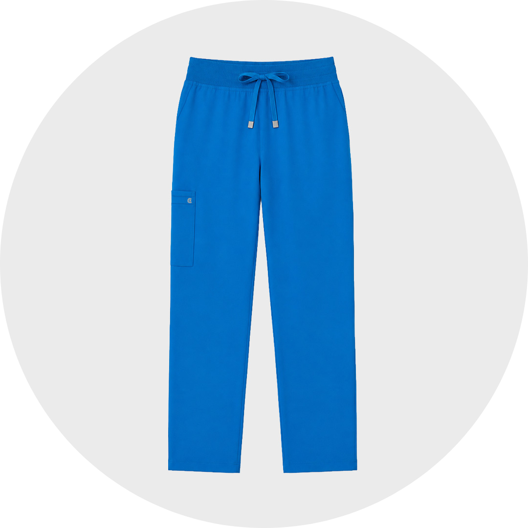 Royal blue plus size scrub trousers with a ribbed elastic drawstring waist and a side cargo pocket with logo snap, shown flat against a light gray circular background.