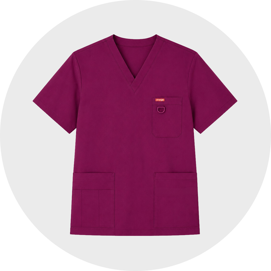 A burgundy short-sleeved women's V-cotton neck scrub top with one chest pocket and two large lower front pockets, shown flat against a light gray circular background.