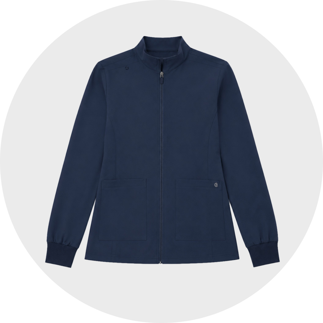 Navy blue women's zip-up scrub jacket with a stand collar, long sleeves, ribbed cuffs, and two front patch pockets, shown against a light gray circular background.